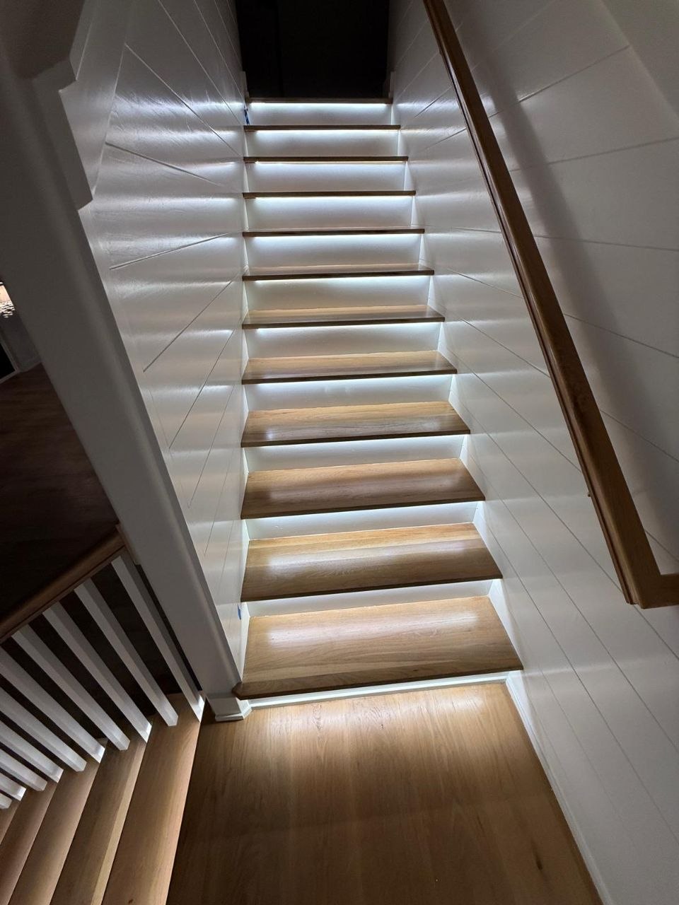 Wood staircase with under-tread LED lighting